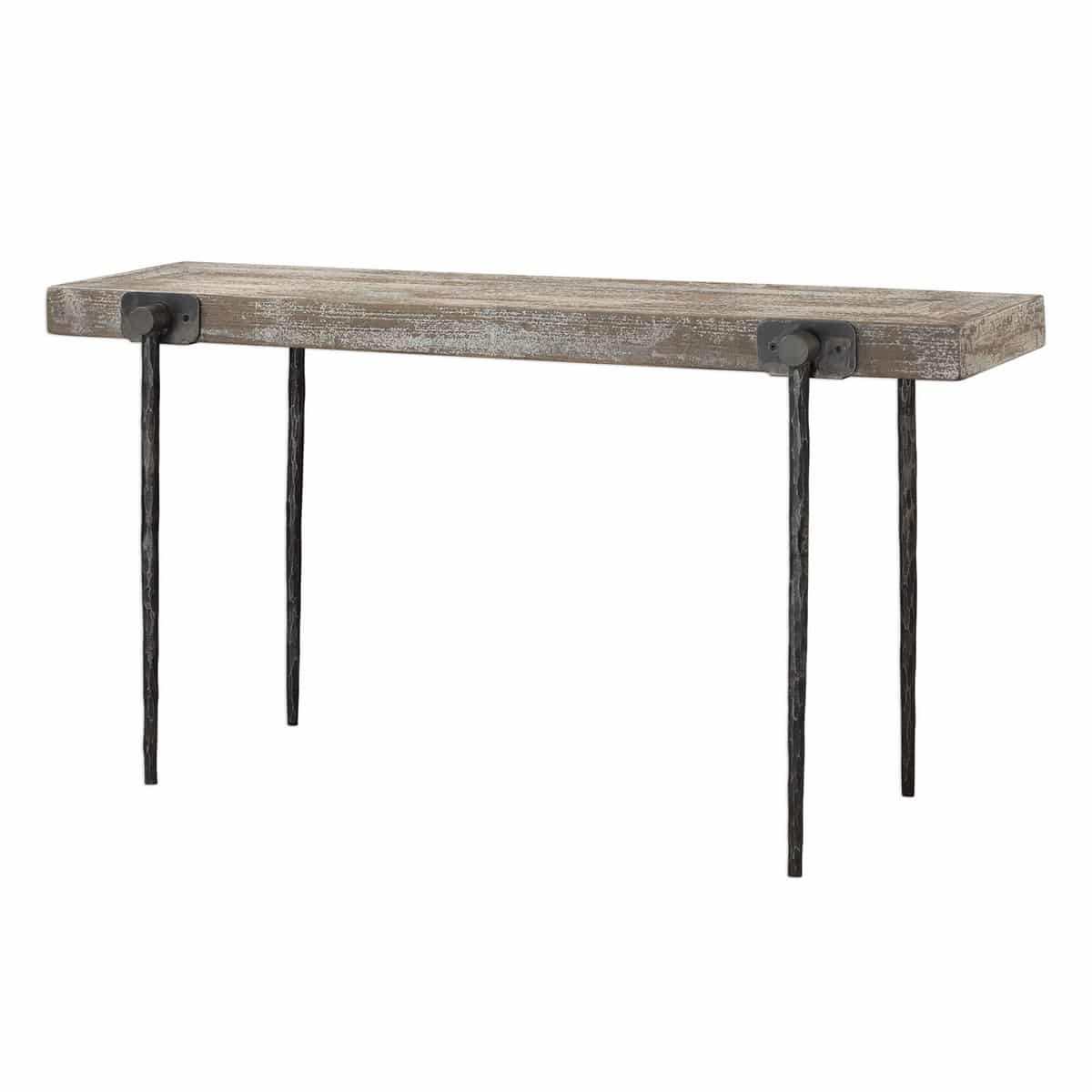 Rustic industrial styling displayed in the tapered cast iron legs featuring a hand chiseled texture. Accented by four oversize iron knobs holding a recycled pine tabletop finished in a sandblasted antique white over natural wood. Solid wood will continue to move with temperature and humidity changes, which can result in small cracks and uneven surfaces, adding to its authenticity and character. Dimensions: 62 W X 32 H X 18 D (in) Weight: 66